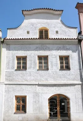 Historická budova se sgrafitovými vzory na fasádě.